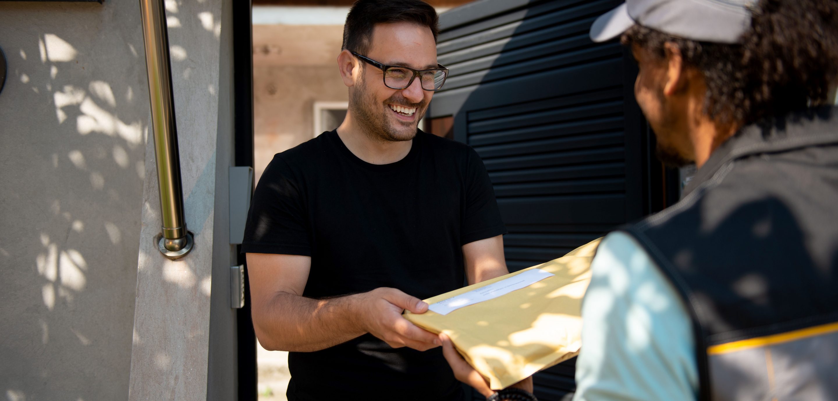 deliveryman giving parcel to happy customer 