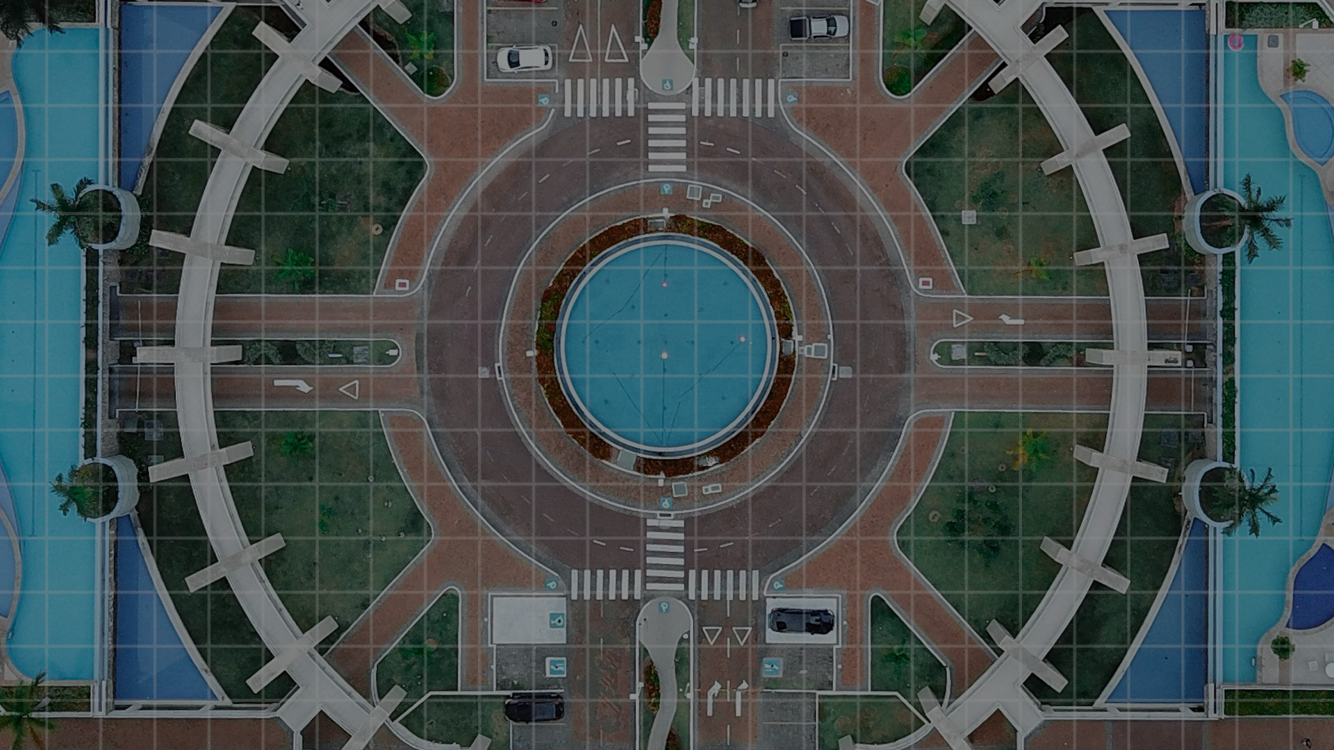 birds eye view of a roundabout with pond in the middle 