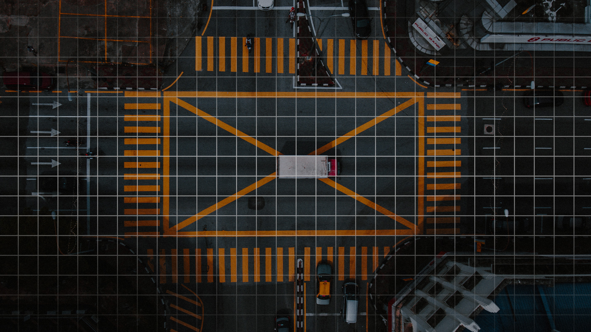 birds eye view of intersection crossing with cars 