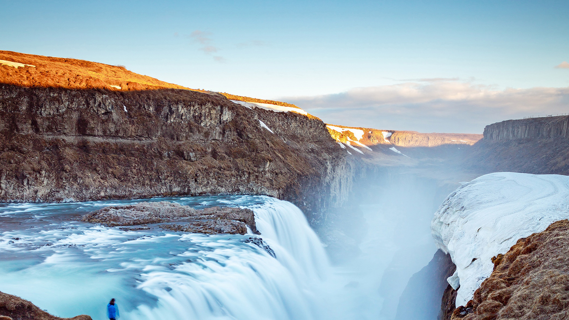 A vast waterfall flows into a gorge