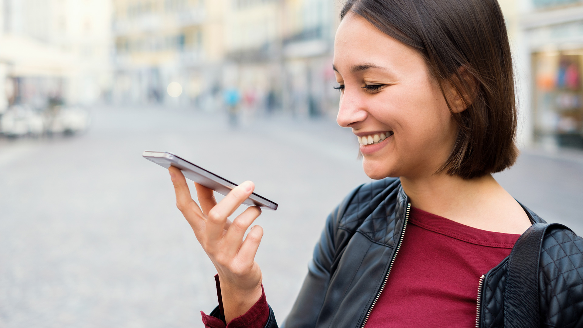 woman smiling at phone