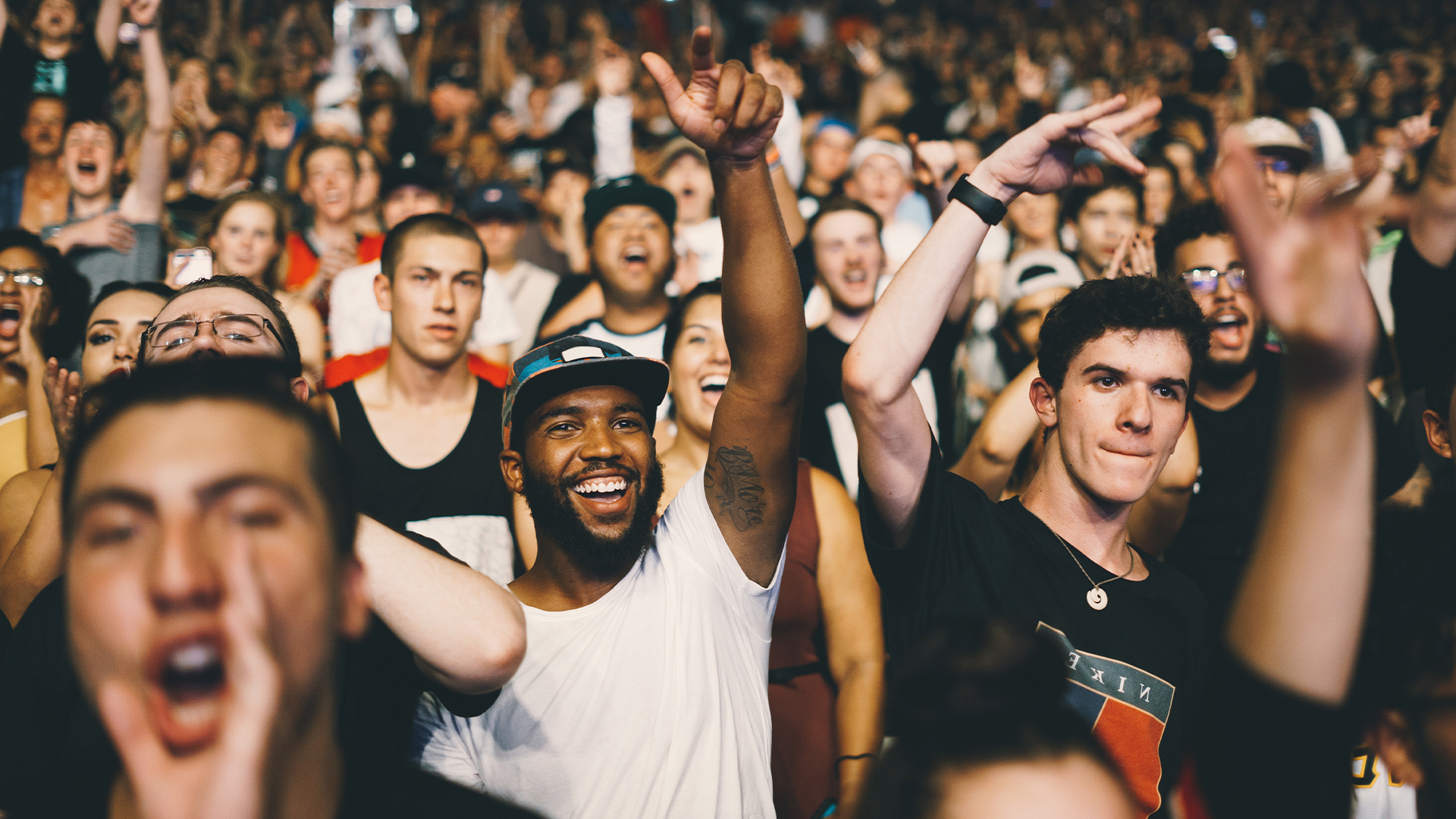crowd dancing with hands in the air