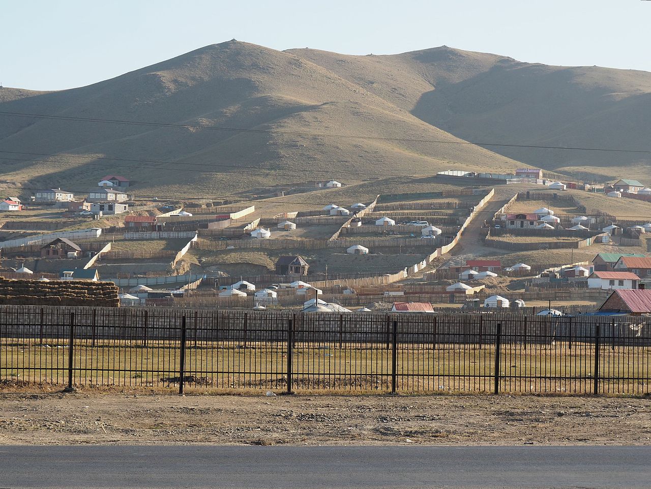 Houses surrounded by fences on a hill