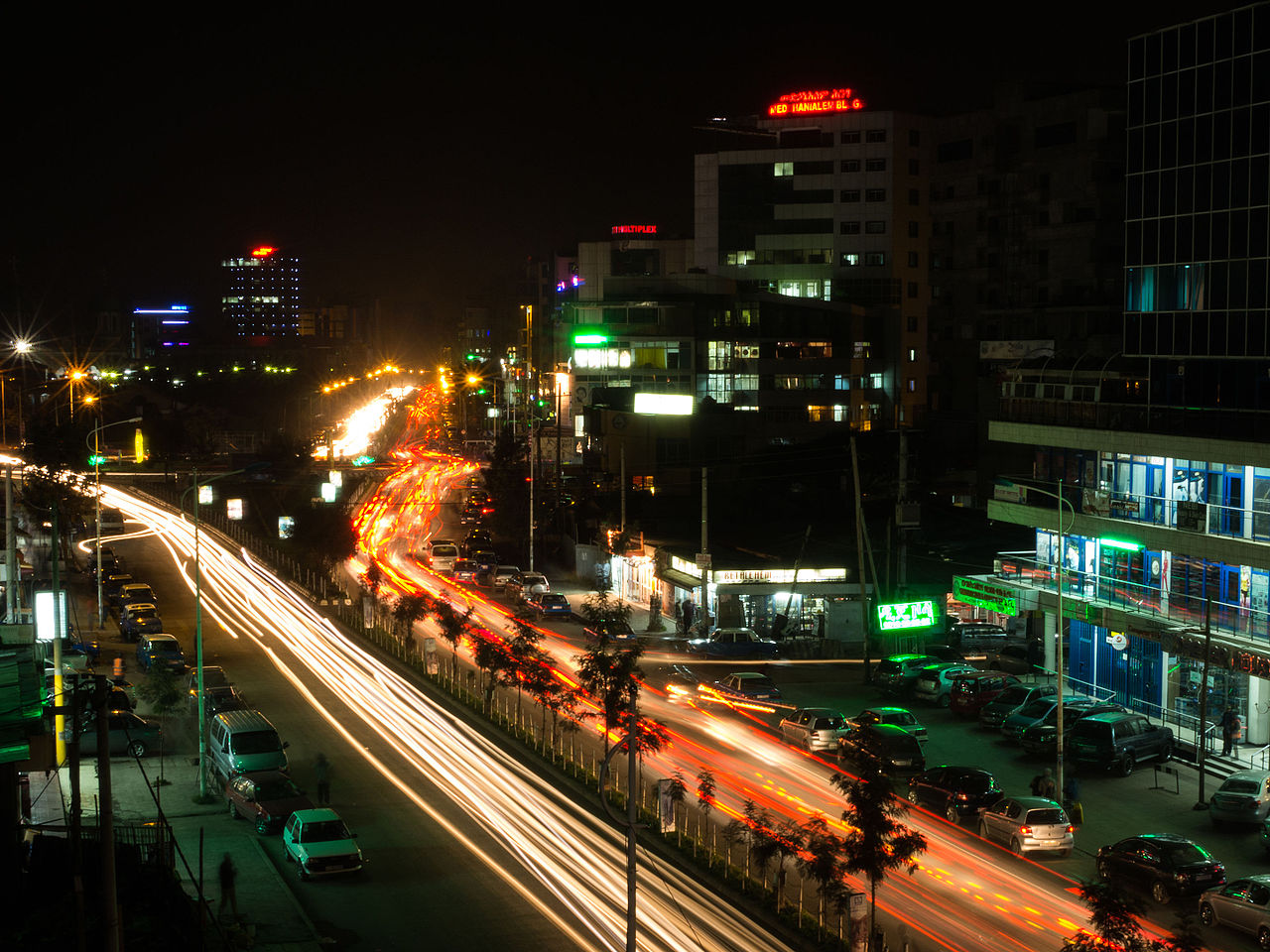 busy road lit up by car lights at night