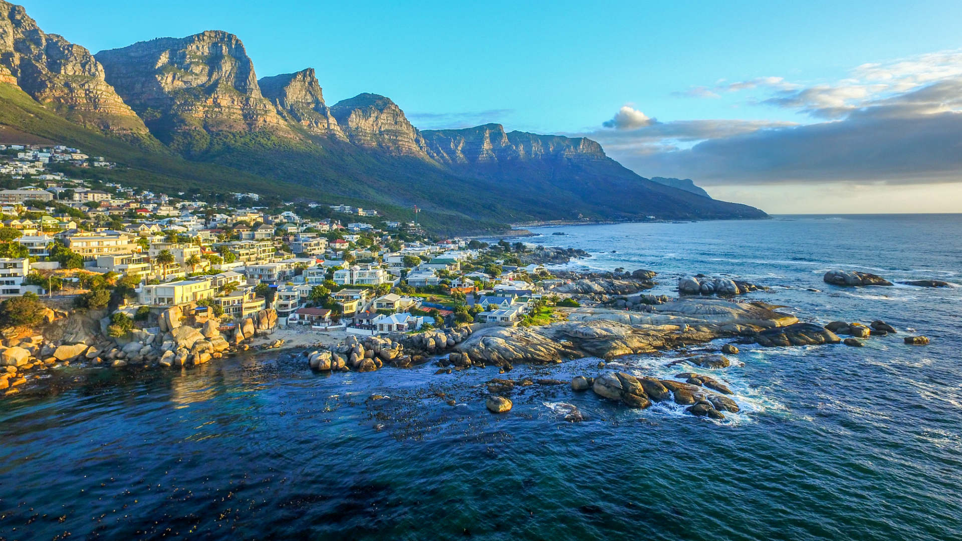 view of costal town with mountains in the background