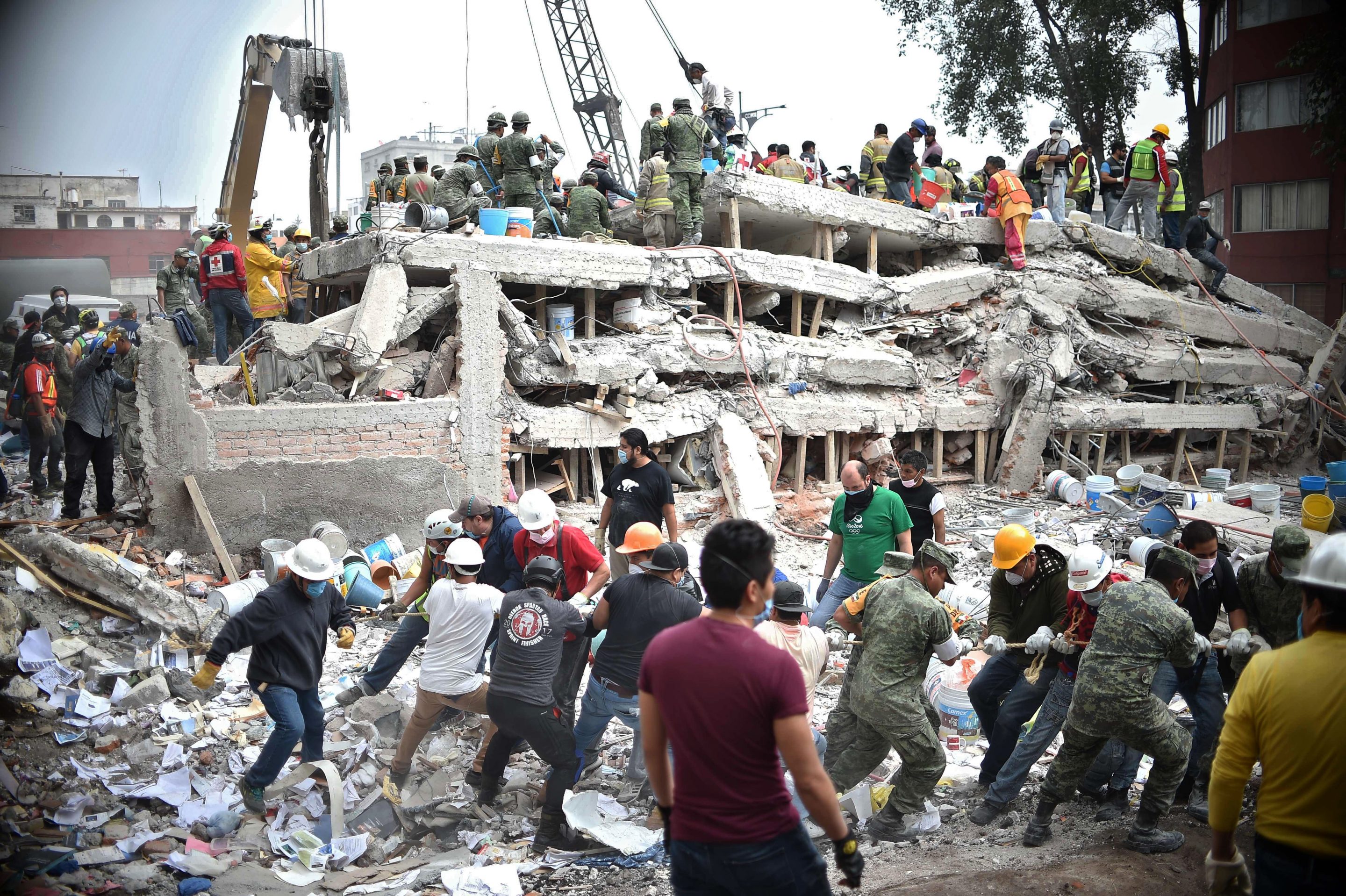 volunteers and rescue services at collapsed building