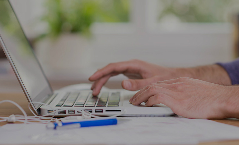 man typing on laptop