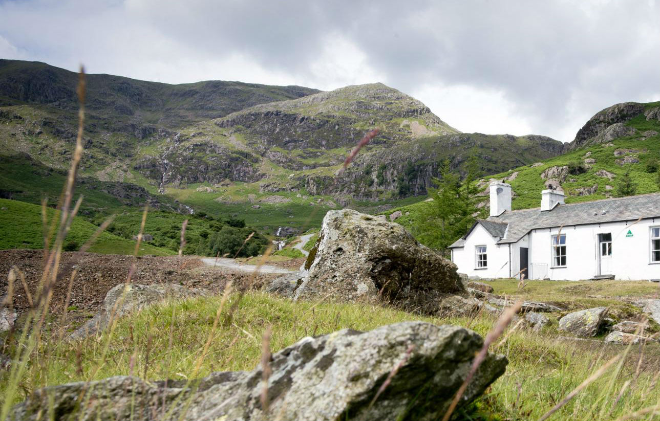 cottage with background of rocky hills in the countryside