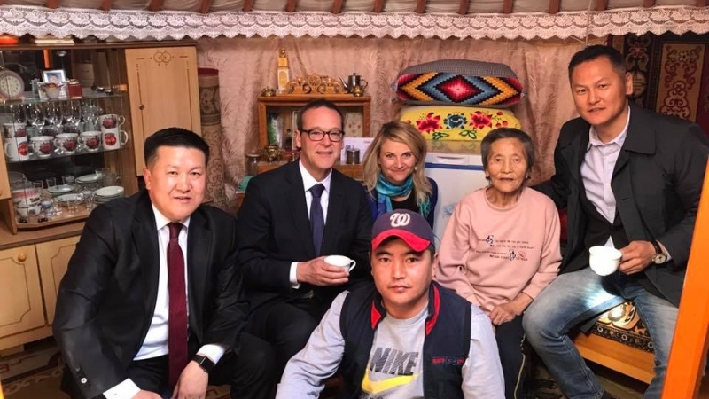 group of people sit posing for a photo