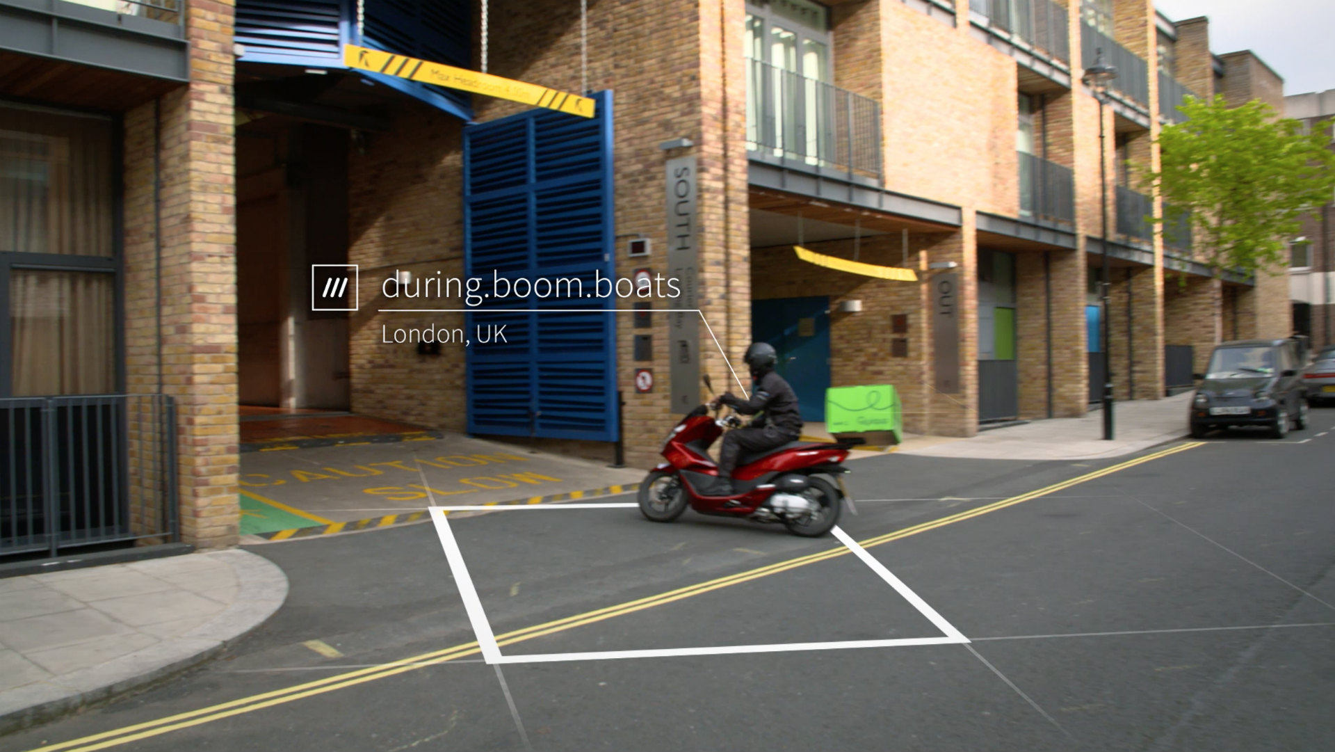 motorcyclist driving into car park at 3 words address during.boom.boats