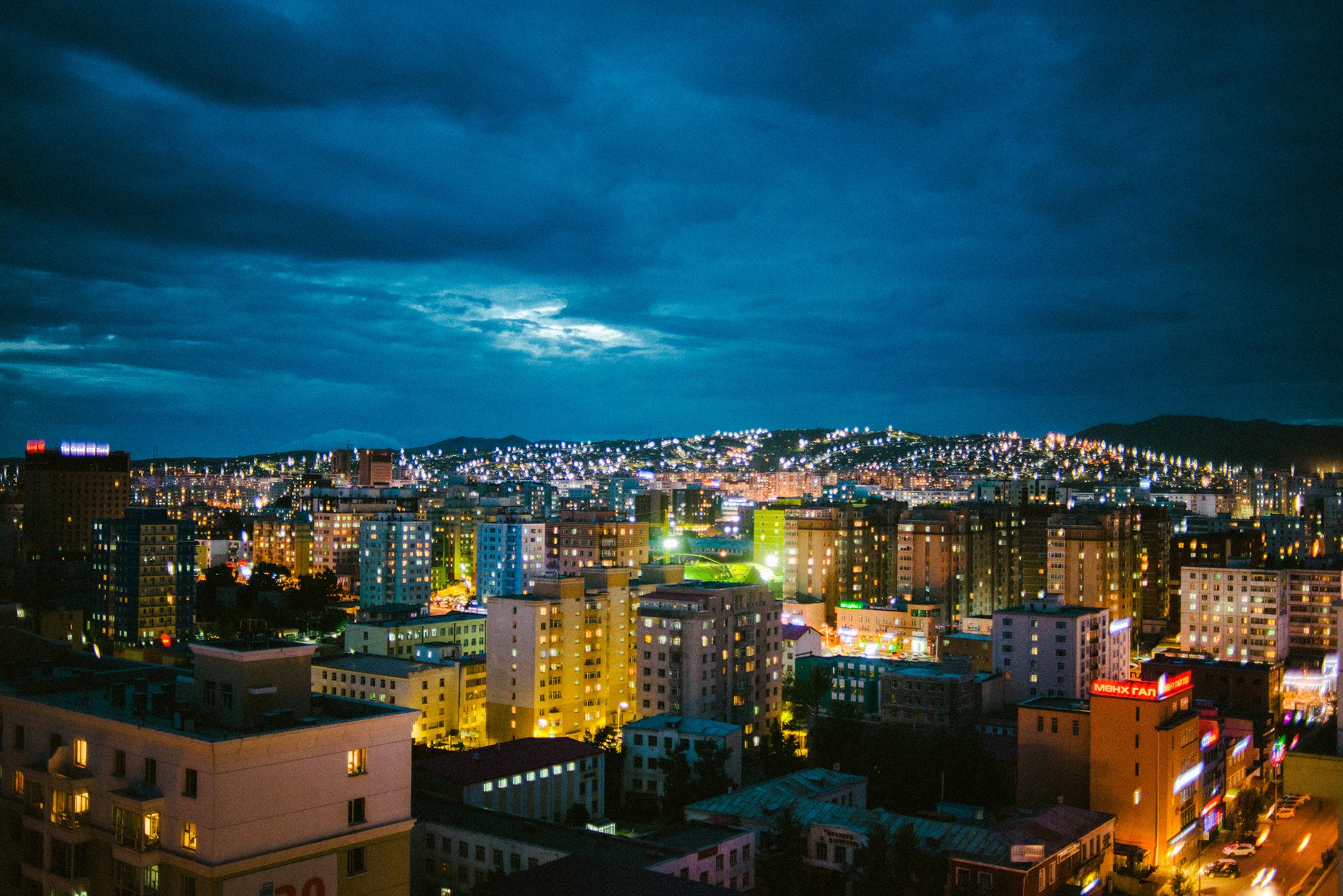 city at night with housing lights covering the landscape