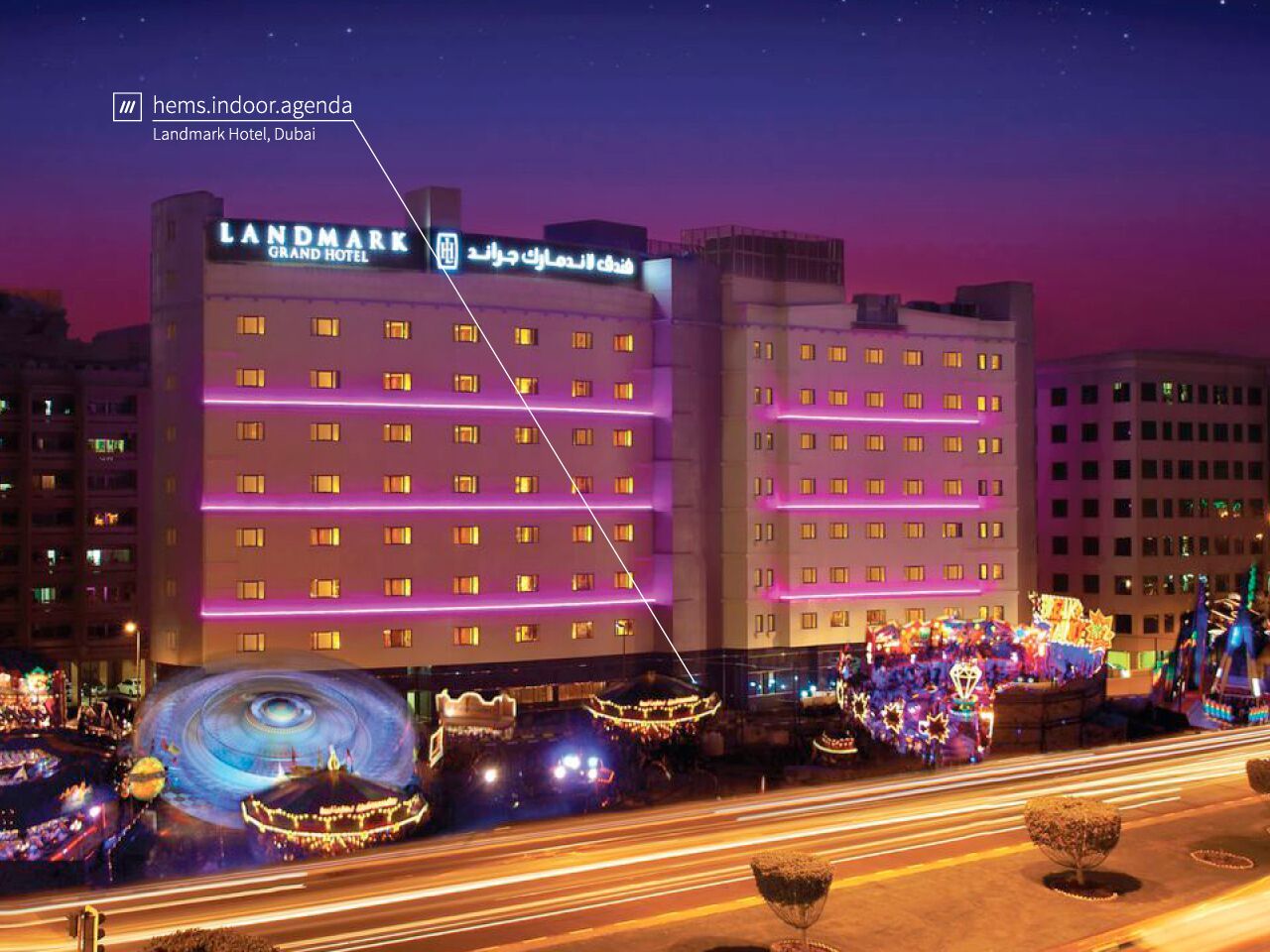 landmark hotel at night lit up by room lights at 3 words address hems.indoor.agenda