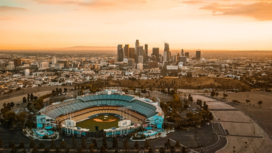 stadium with city skyline at sunset 