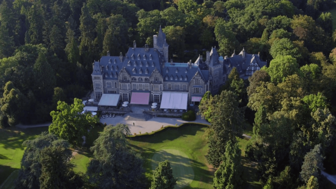 grand hotel surrounded by a forest 