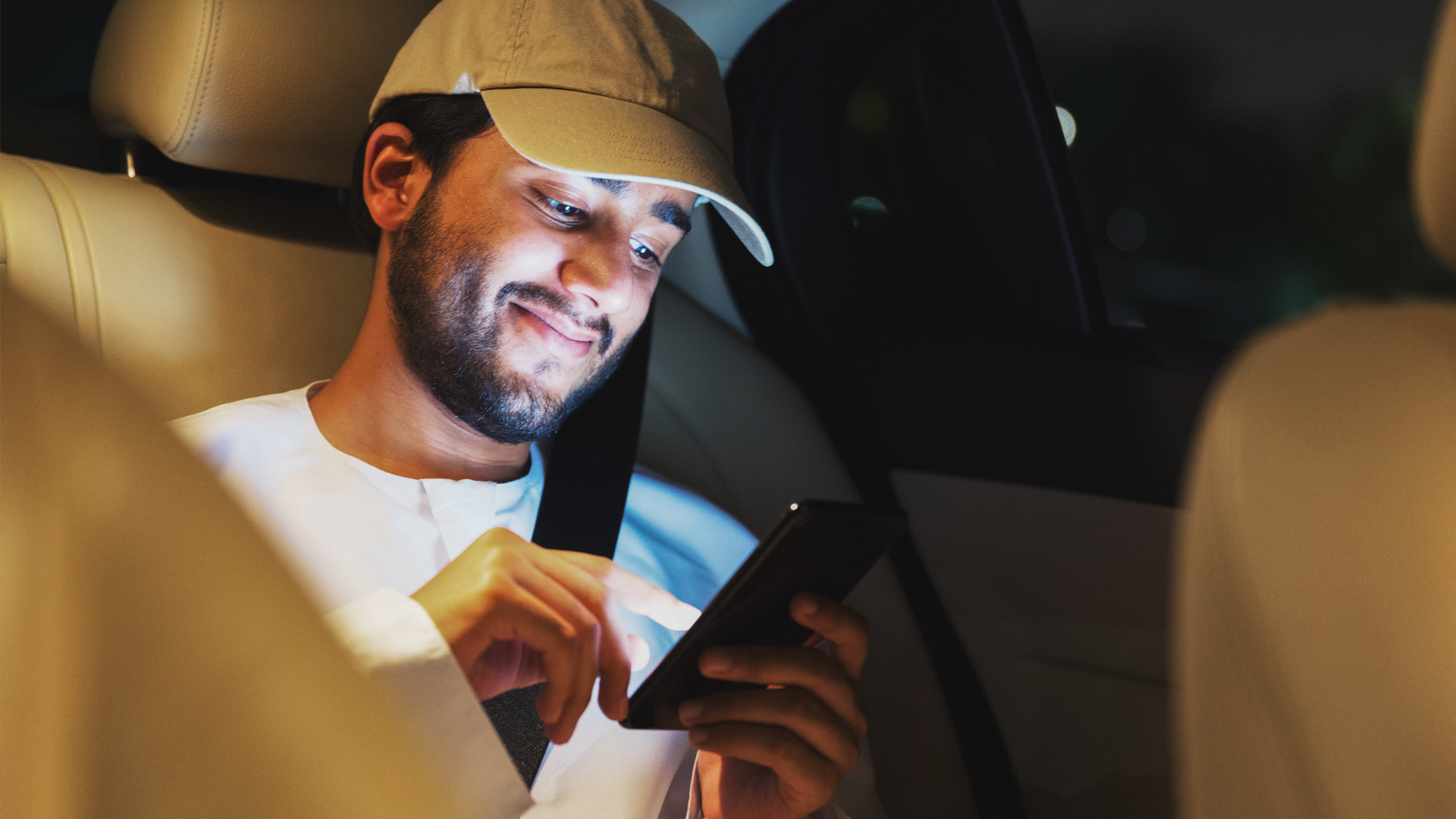 Man on a smartphone in a car 