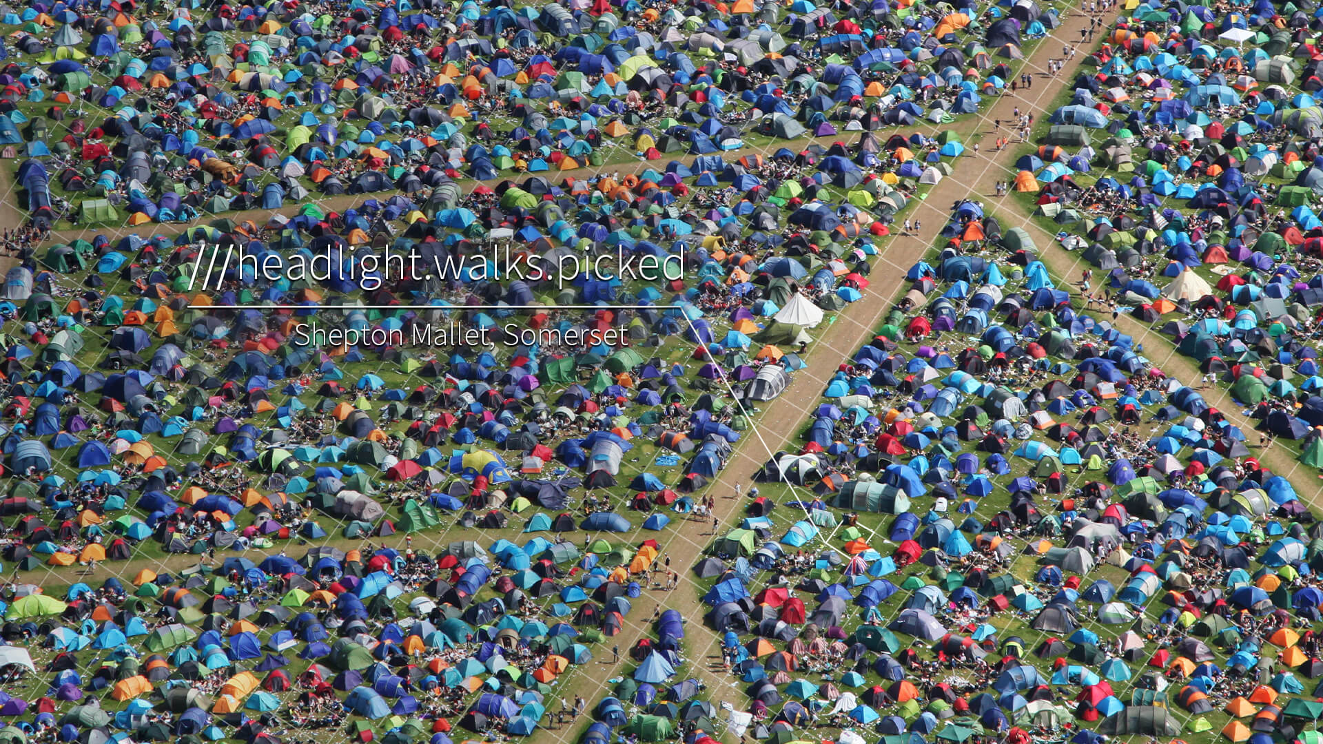 Hundreds of tents at a festival with 3 word address Headlight.Walks.Picked