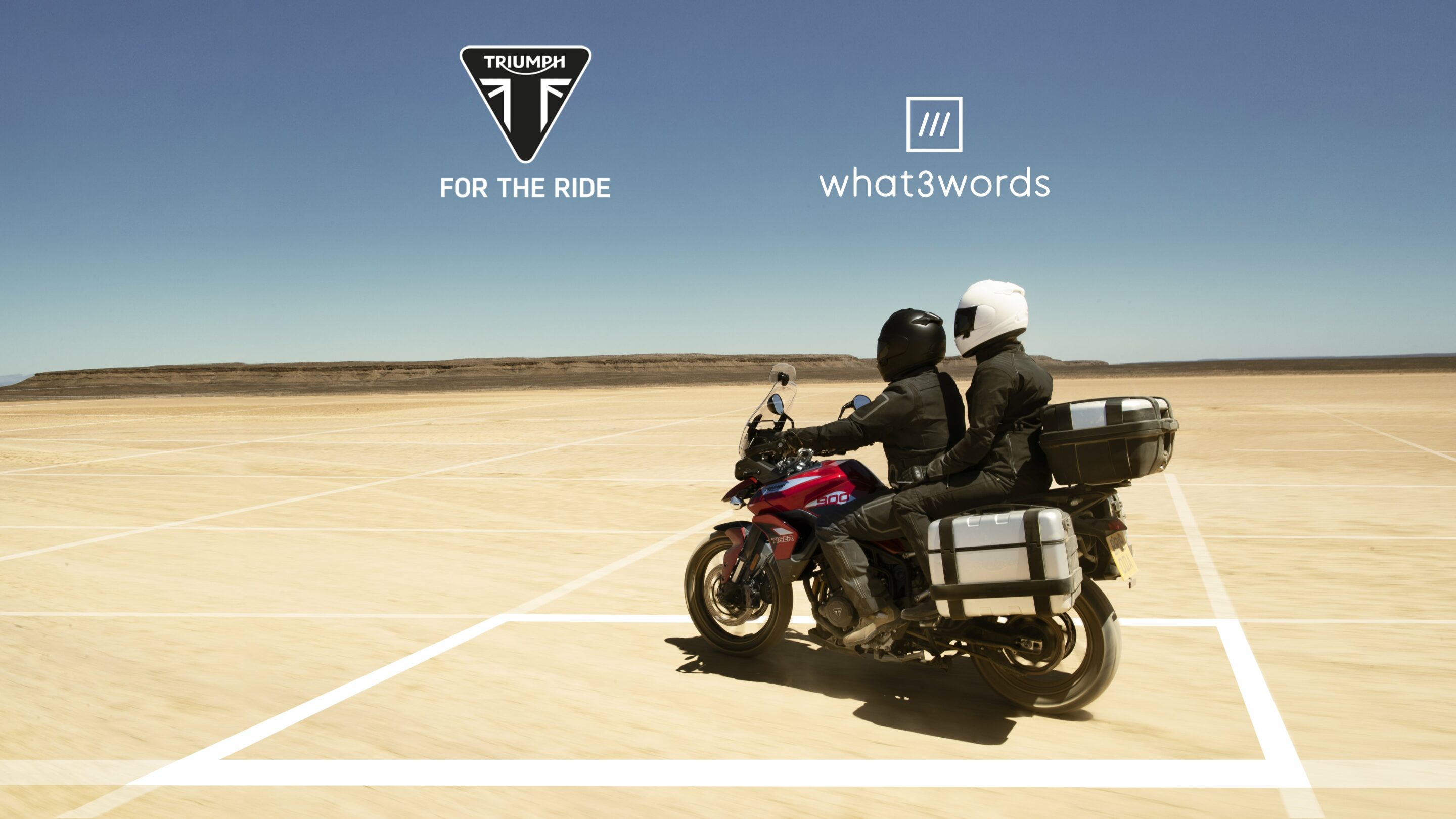 Motorcyclist driving with passenger with what 3 words grid covering ground