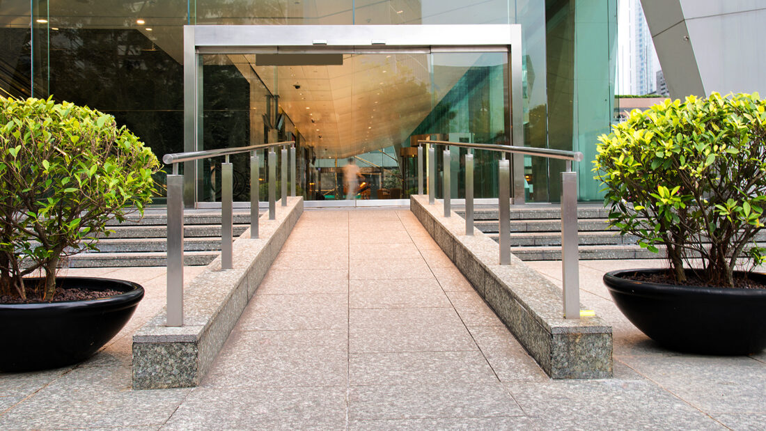 Accessible building entrance in Calgary showing ramp and automatic doors