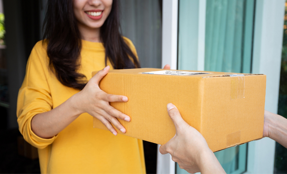 Person receiving package from delivery driver